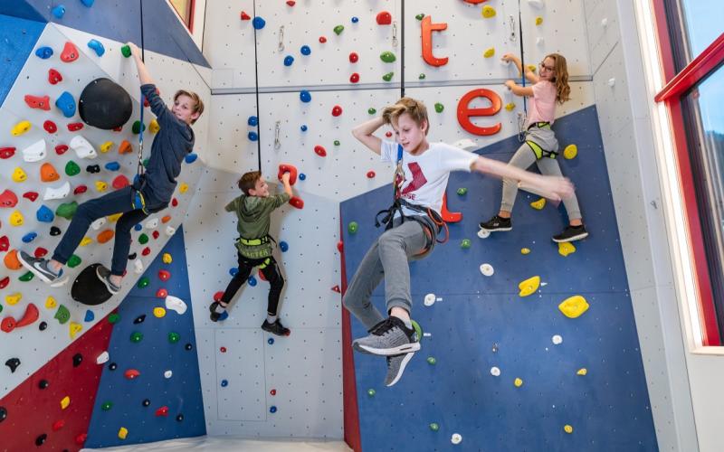 Kletternde Kinder im Zauchenseehof an der Kletterwand