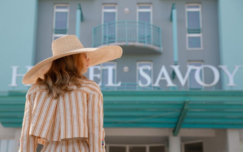 Eine Dame vor dem Eingangsbereich des Hotels Savoy Grado